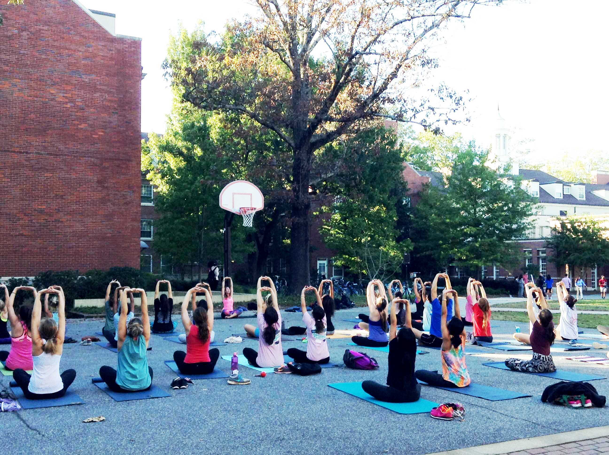 Students practicing yoga with University Health Center instructor Alice Huff